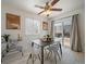 Dining area with modern table set, stylish decor, and sliding glass doors to the backyard at 4437 Cornish Way, Denver, CO 80239