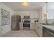 Well-lit kitchen featuring stainless steel appliances, white cabinets, and marble countertops at 4437 Cornish Way, Denver, CO 80239
