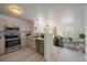 Modern kitchen open to the living area, equipped with stainless steel appliances and white cabinetry at 4437 Cornish Way, Denver, CO 80239