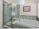 Bright bathroom with a tub and tiled shower at 1011 S Valentia St # 121, Denver, CO 80247