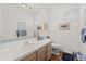 Well-lit bathroom with tile countertops, framed artwork, and a clean design featuring a coordinated color scheme at 1011 S Valentia St # 121, Denver, CO 80247