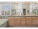 Bright bathroom featuring a double vanity, tiled backsplash, and separate tub and shower at 1011 S Valentia St # 121, Denver, CO 80247