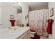 Bathroom featuring a single vanity, large mirror, and patterned shower curtain at 1011 S Valentia St # 121, Denver, CO 80247