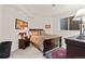 Inviting bedroom with patterned bedding, bedside table, and window at 1011 S Valentia St # 121, Denver, CO 80247