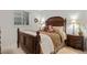 Comfortable bedroom with wooden headboard, patterned bedding, and window at 1011 S Valentia St # 121, Denver, CO 80247
