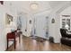 Bright entryway with hardwood floors, white walls, and an elegant chandelier that compliments a lovely foyer at 1011 S Valentia St # 121, Denver, CO 80247