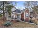 Inviting two-story home boasts a blend of neutral siding and brick, complemented by mature trees and a well-manicured lawn at 1011 S Valentia St # 121, Denver, CO 80247