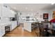 Bright, all-white kitchen with stainless steel appliances and hardwood flooring at 1011 S Valentia St # 121, Denver, CO 80247