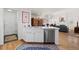 Modern kitchen with stainless steel appliances, white cabinetry, and an open layout at 1011 S Valentia St # 121, Denver, CO 80247