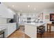 Spacious kitchen with hardwood floors, white cabinets, stainless steel appliances, and tiled countertops at 1011 S Valentia St # 121, Denver, CO 80247