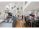 Open concept living room with vaulted ceilings, hardwood floors, and kitchen access perfect for entertaining at 1011 S Valentia St # 121, Denver, CO 80247