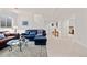 Comfortable living room with plush blue seating, a glass coffee table, and carpeted floors at 1011 S Valentia St # 121, Denver, CO 80247