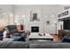 Relaxing living room with a fireplace, built-ins, plantation shutters, and comfortable seating at 1011 S Valentia St # 121, Denver, CO 80247