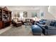 Cozy living room with leather furniture, area rug, and ample natural light at 1011 S Valentia St # 121, Denver, CO 80247