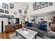 Cozy living room with fireplace, hardwood floors, and lots of natural light at 1011 S Valentia St # 121, Denver, CO 80247