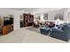 Spacious living room with plush seating, bookcase, and neutral carpeting at 1011 S Valentia St # 121, Denver, CO 80247