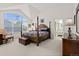 Spacious main bedroom with a four poster bed, large window, and vaulted ceilings at 1011 S Valentia St # 121, Denver, CO 80247