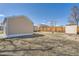 Expansive backyard offering space with a detached garage and storage shed at 1805 W Stoll Pl, Denver, CO 80221