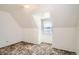 Cozy bedroom featuring an angled wall with window and neutral-toned carpet at 1805 W Stoll Pl, Denver, CO 80221