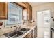 View of kitchen with sink, window and view into another room at 1805 W Stoll Pl, Denver, CO 80221