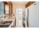 View of kitchen with sink, window and refrigerator at 1805 W Stoll Pl, Denver, CO 80221