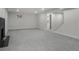 Large open basement with gray carpet, fireplace, and access to additional rooms, perfect for flexible living at 2203 S Harlan St, Denver, CO 80227