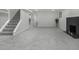 Open basement area with neutral carpet, modern lighting, fireplace, and convenient access to additional rooms at 2203 S Harlan St, Denver, CO 80227