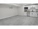 Finished basement featuring neutral carpet and a modern kitchenette with sleek white cabinetry at 2203 S Harlan St, Denver, CO 80227