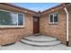 Charming brick home with front steps and a cozy, covered entryway, number on the door is 2203 at 2203 S Harlan St, Denver, CO 80227