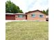 Charming brick home featuring a well-maintained lawn and attached garage at 2203 S Harlan St, Denver, CO 80227