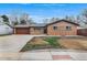 Charming brick home featuring an attached garage and a well-manicured front yard at 2203 S Harlan St, Denver, CO 80227