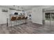 Bright, modern kitchen with stainless steel appliances, quartz countertops, and an island with bar seating at 2203 S Harlan St, Denver, CO 80227