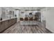 Bright, modern kitchen with stainless steel appliances, quartz countertops, and an island with bar seating at 2203 S Harlan St, Denver, CO 80227