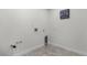 Bright laundry room with tile floor, hookups and a decorative 