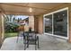 Covered patio includes sliding glass doors and chairs offer an inviting outdoor space at 2203 S Harlan St, Denver, CO 80227