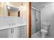 Bright bathroom featuring dual sinks, updated fixtures, and a modern glass-enclosed shower at 2 Adams St # 1507, Denver, CO 80206