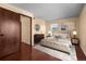 Cozy bedroom with a round mirror, complemented by stylish furniture and ample natural light at 2 Adams St # 1507, Denver, CO 80206