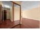 Bright room featuring hardwood floors and a mirrored sliding door closet at 2 Adams St # 1507, Denver, CO 80206