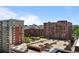 Scenic city view from the building, overlooking multiple buildings and rooftops parking, showcasing urban living at 2 Adams St # 1507, Denver, CO 80206