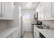 Efficient kitchen boasts white cabinets, stainless appliances, and a window that offers natural light at 2 Adams St # 1507, Denver, CO 80206