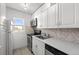 Efficient kitchen boasts white cabinets, stainless appliances, and a window that offers natural light at 2 Adams St # 1507, Denver, CO 80206