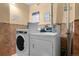 Bright laundry room featuring white washer and dryer sets and tiled accents, offering convenient on-site laundry facilities at 2 Adams St # 1507, Denver, CO 80206