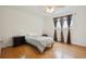 Small bedroom with wood floors and window coverings at 9673 Ironton St, Commerce City, CO 80022