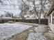 Fenced backyard with patio and some snowy patches at 1780 Oswego St, Aurora, CO 80010