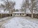 Backyard exterior features a fenced yard with mature trees and a view of the home at 1780 Oswego St, Aurora, CO 80010