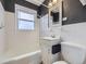 A bathroom with a shower/tub combination, a single sink vanity, and a standard toilet at 1780 Oswego St, Aurora, CO 80010