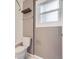 Well-lit bathroom with window, toilet, and a shelf for storage at 1780 Oswego St, Aurora, CO 80010