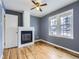 Comfortable bedroom with a cozy fireplace, natural light from the windows, and hardwood floors at 1780 Oswego St, Aurora, CO 80010