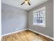 This is a bedroom featuring grey walls, hardwood floors, ceiling fan, and a window with blinds at 1780 Oswego St, Aurora, CO 80010