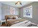 Staged bedroom with a large window, hardwood floor, artwork, and natural light at 1780 Oswego St, Aurora, CO 80010